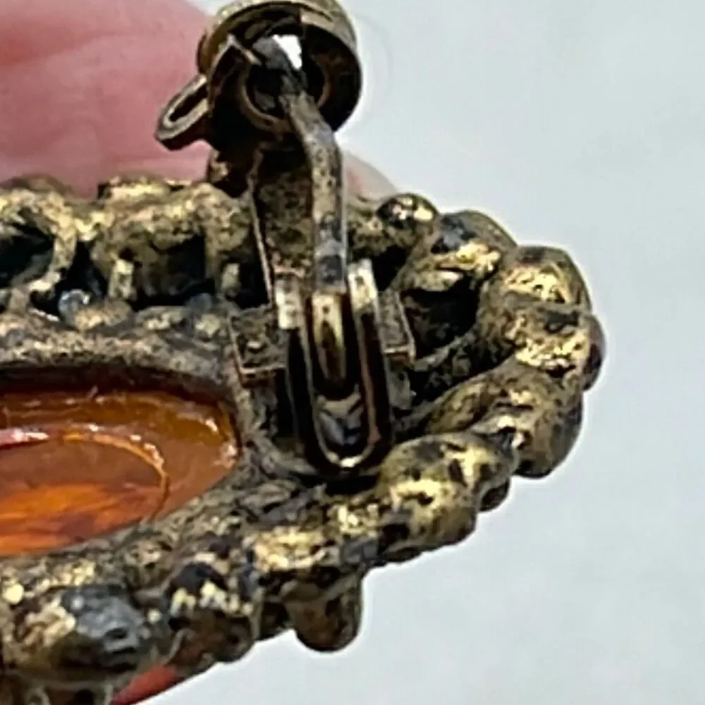 Vintage ornate amber colored brooch.